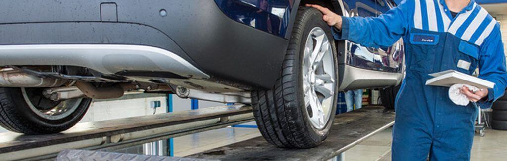 A mechanic looking over a vehicle