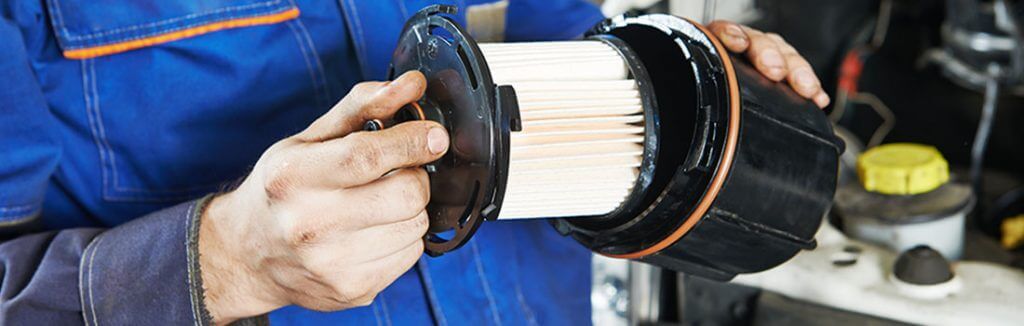 A mechanic changing an air filter